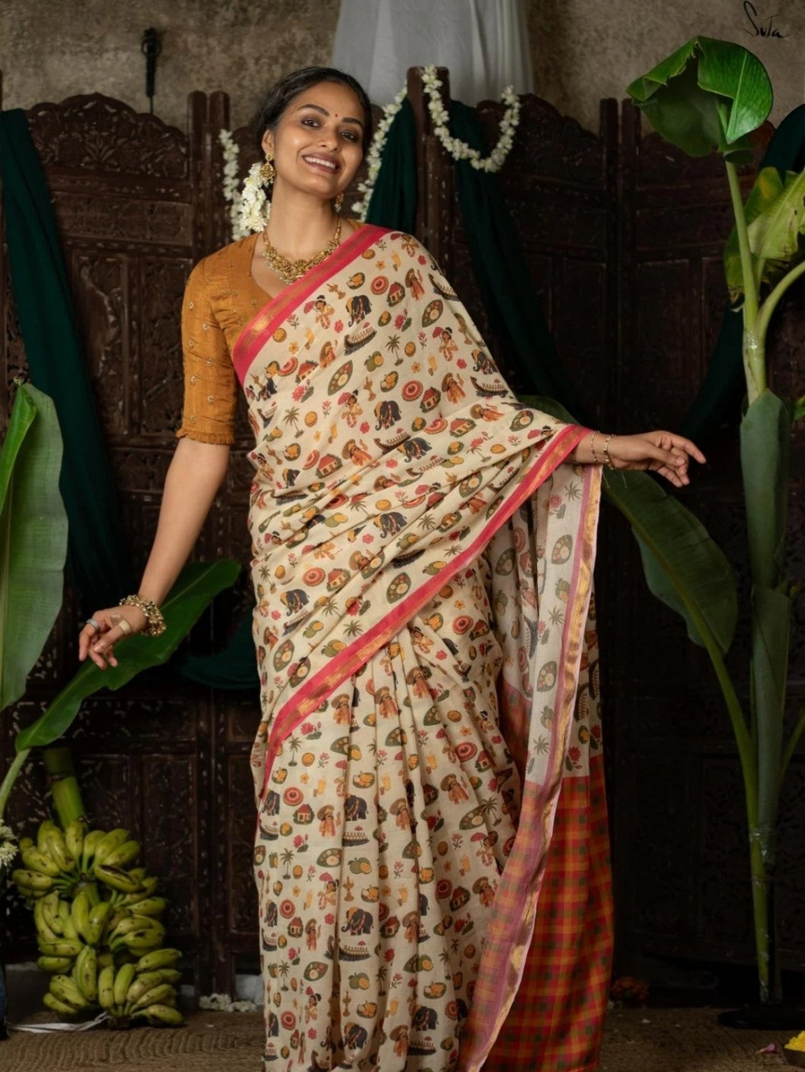 Full look of cream folk-art printed saree with checked pallu