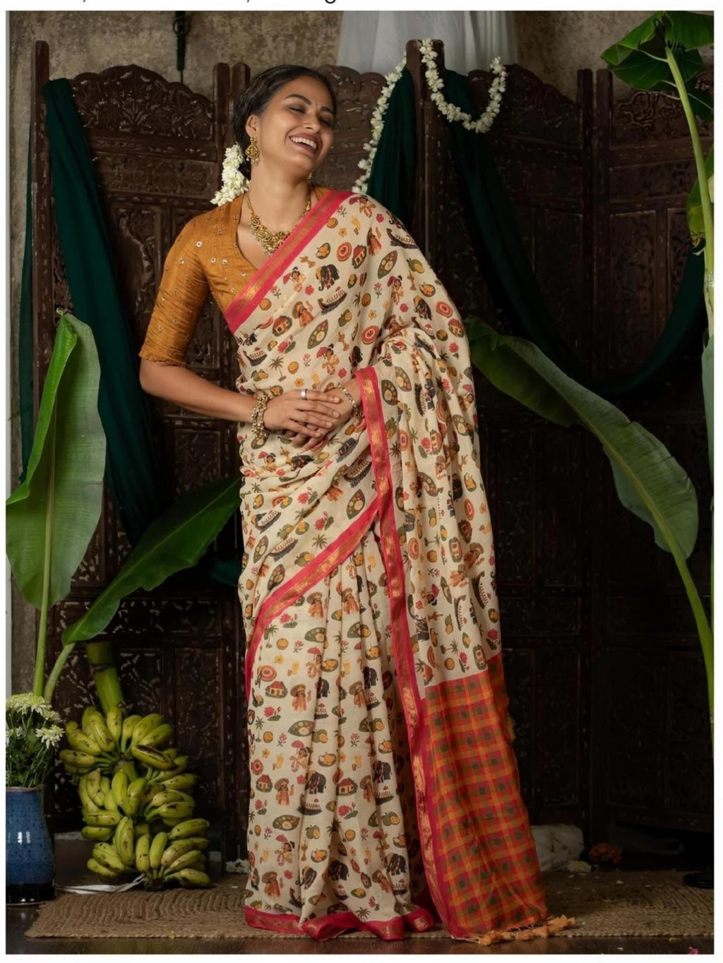 Model wearing cream saree with folk-inspired print and pink border