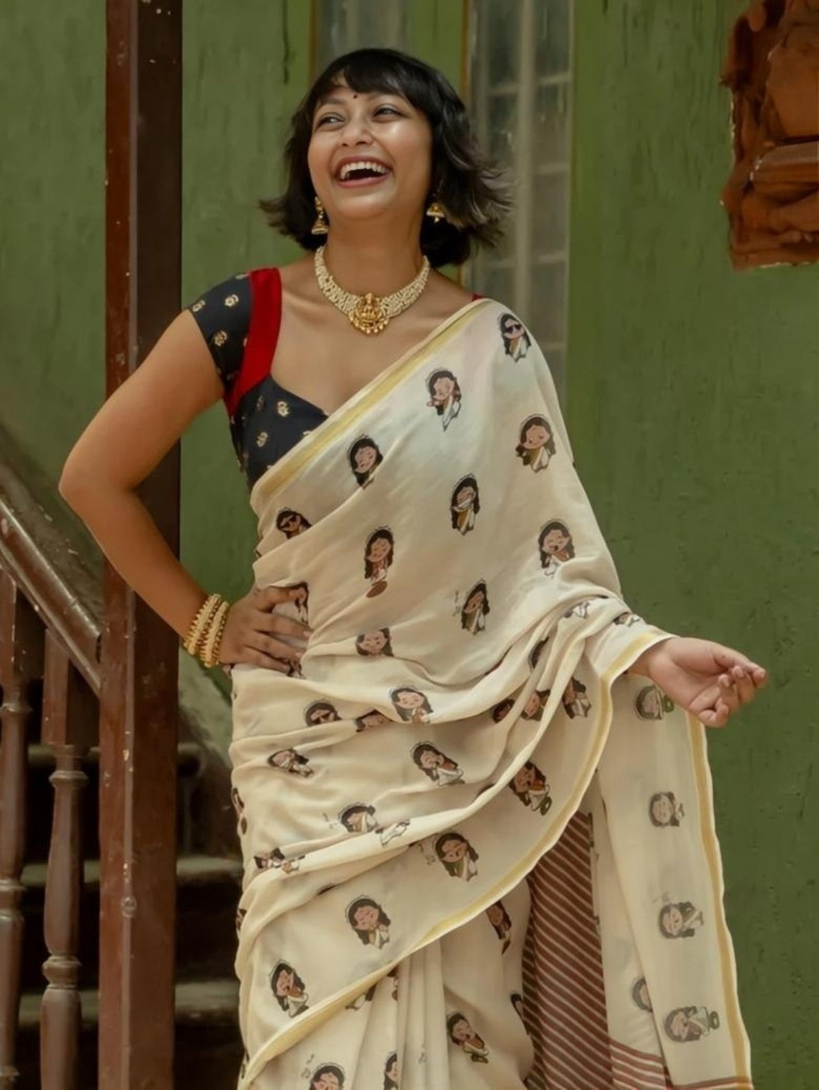 Cream saree with illustrated girl motifs and fine gold border