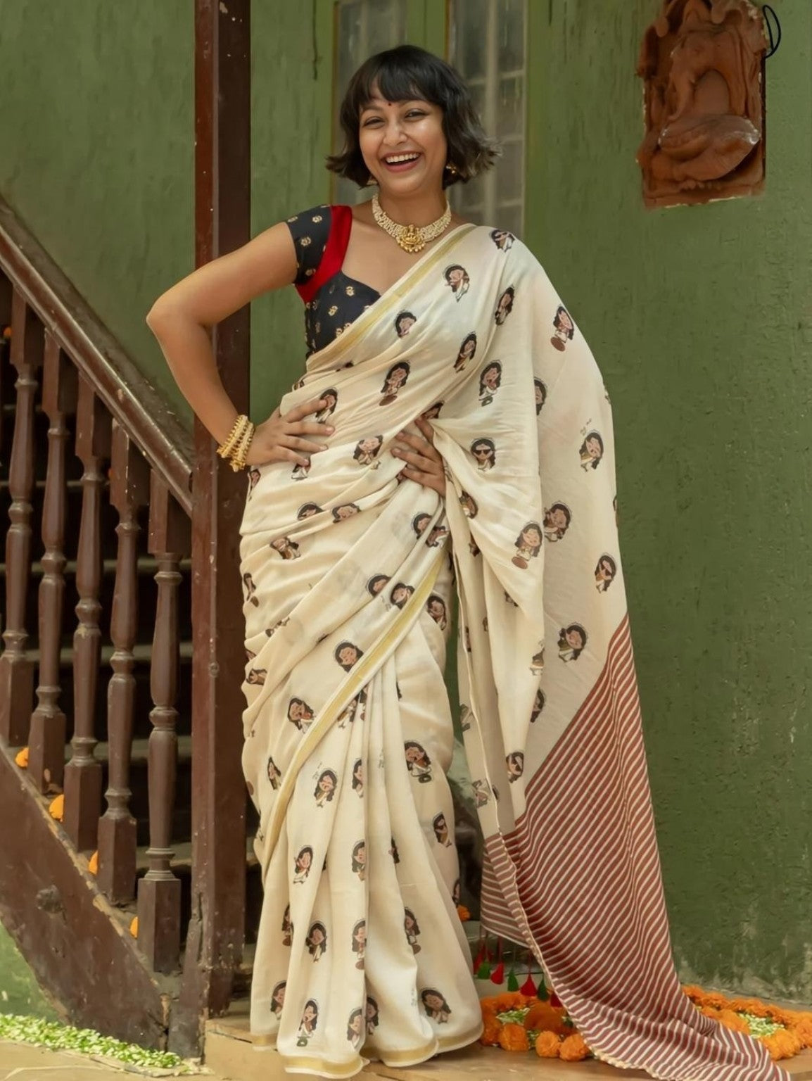 Model wearing cream printed saree with brown striped pallu and golden border