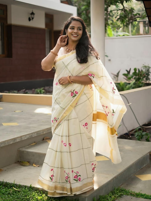 Full-length cream saree with floral details and gold border