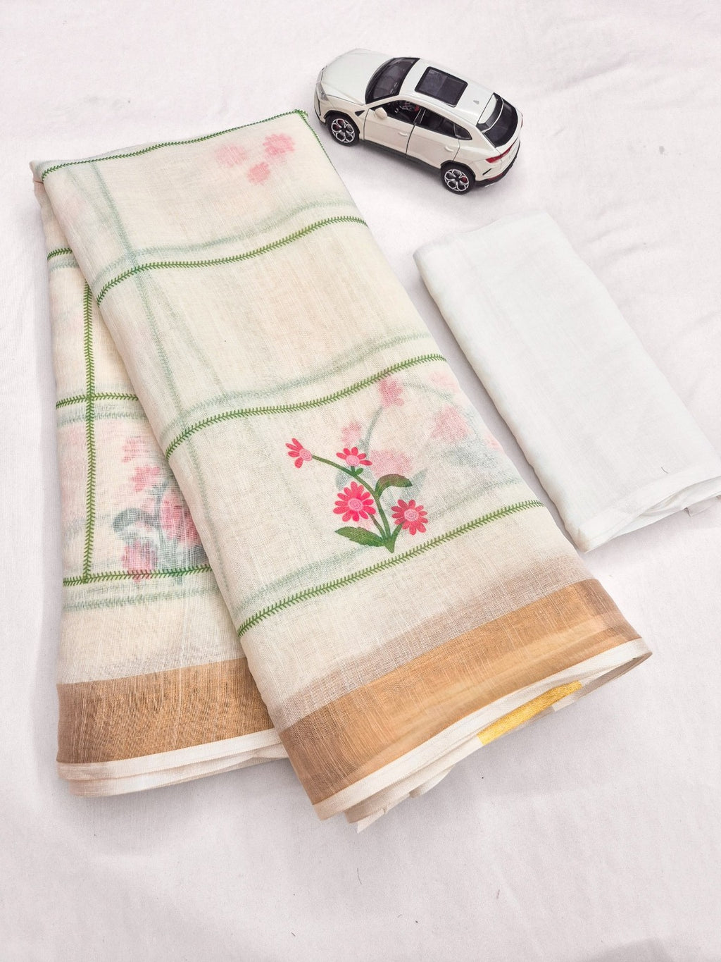 Cream linen saree with pink flower print and fine grid pattern