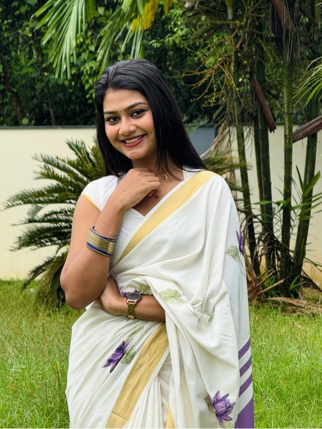 White saree with purple lotus floral print and golden border close-up