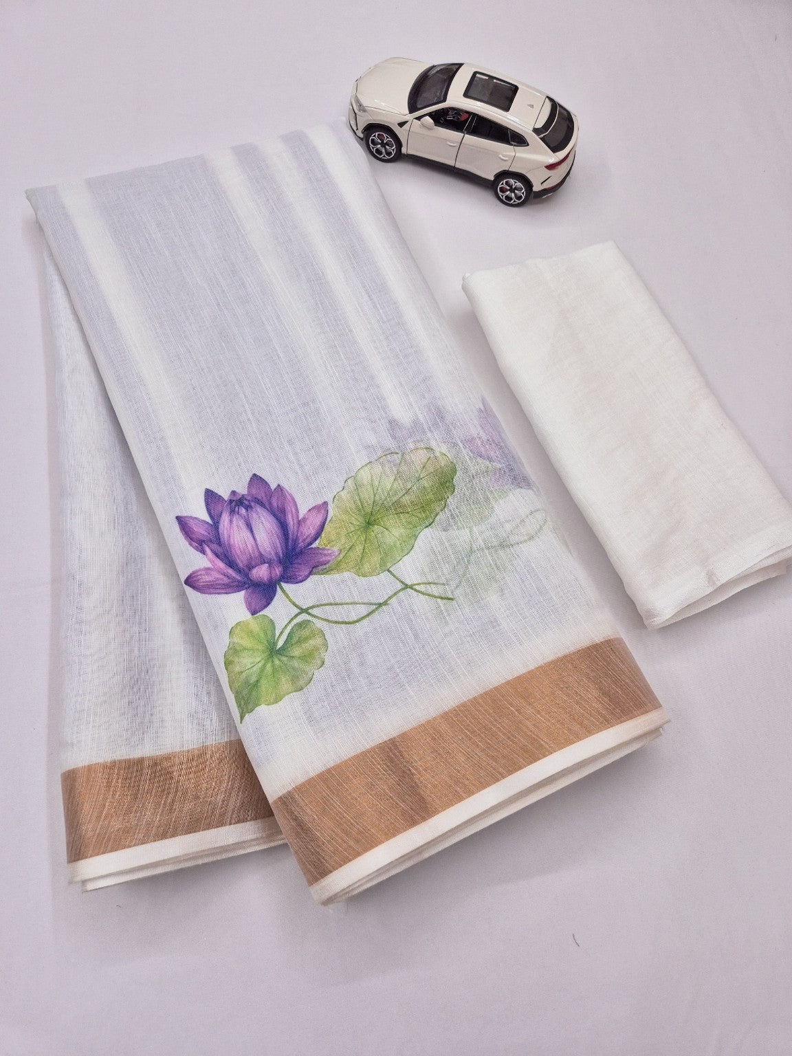 White saree with purple lotus print and matching blouse