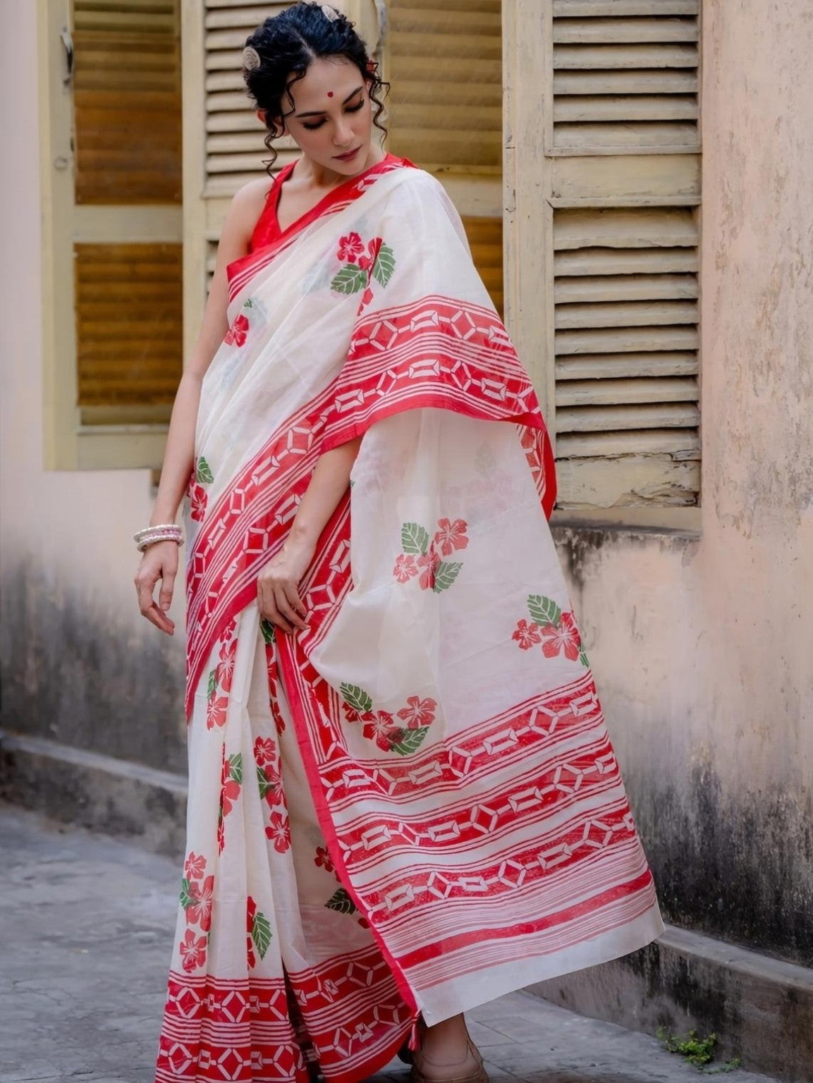Red geometric border and floral print on white saree