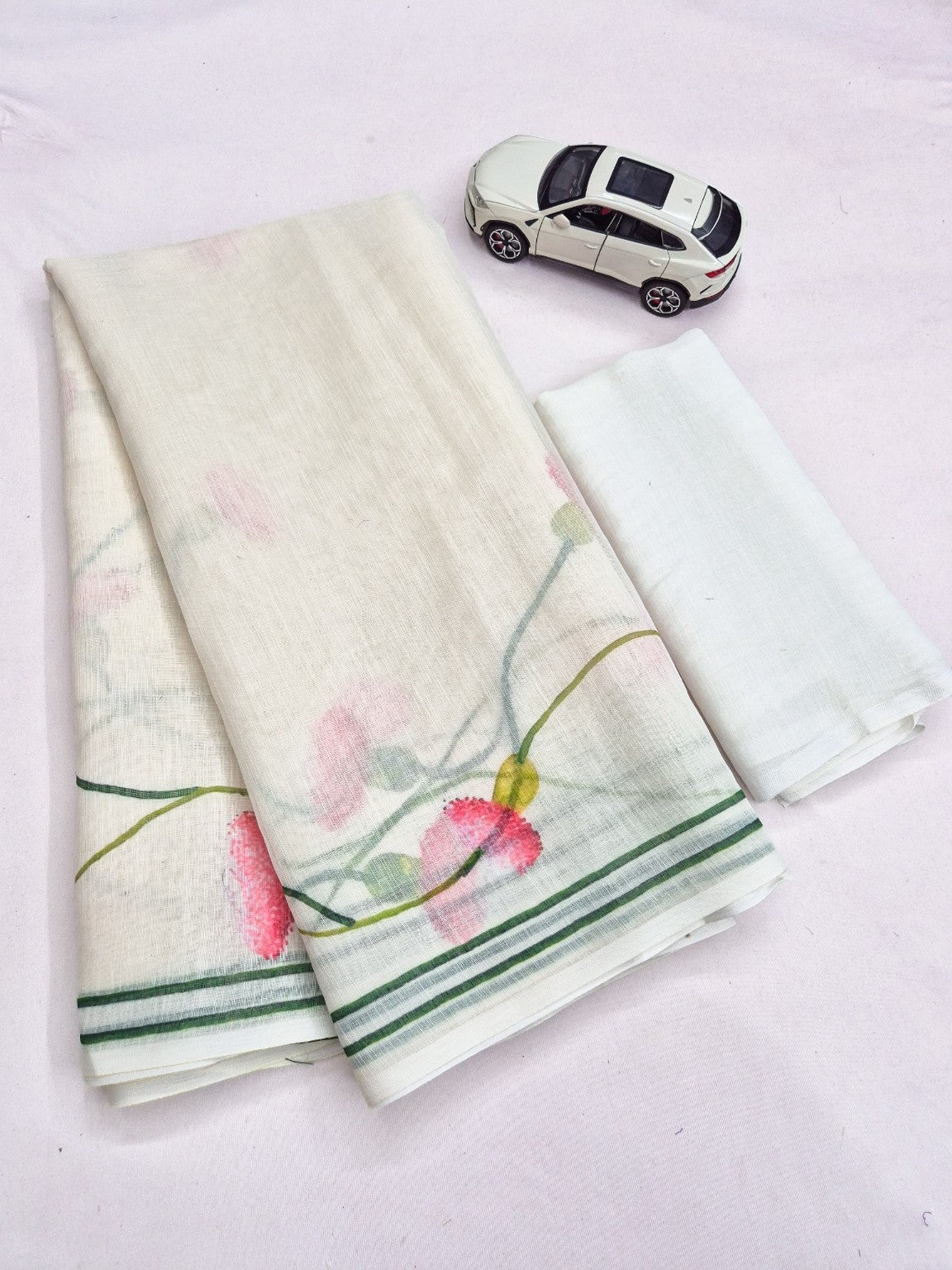 Folded ivory linen saree with pink floral print and matching blouse piece
